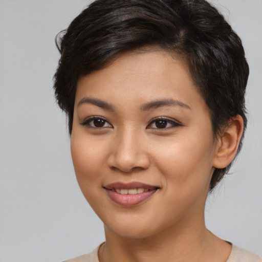 Joyful latino young-adult female with short  brown hair and brown eyes