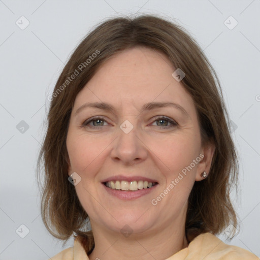 Joyful white adult female with medium  brown hair and grey eyes