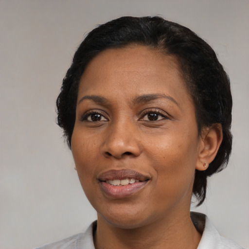 Joyful black adult female with medium  black hair and brown eyes