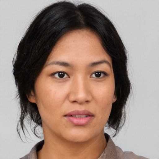 Neutral asian adult female with medium  black hair and brown eyes