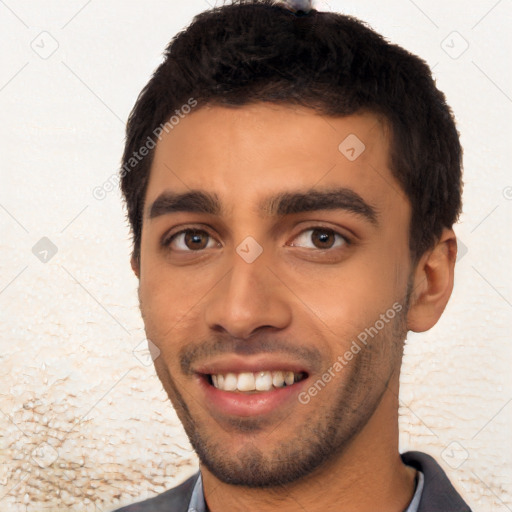 Joyful latino young-adult male with short  black hair and brown eyes