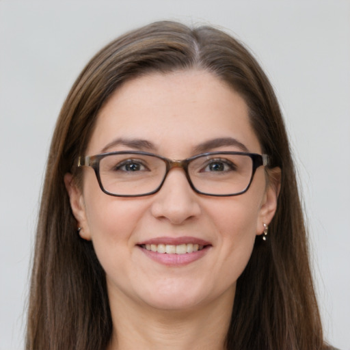 Joyful white young-adult female with long  brown hair and grey eyes