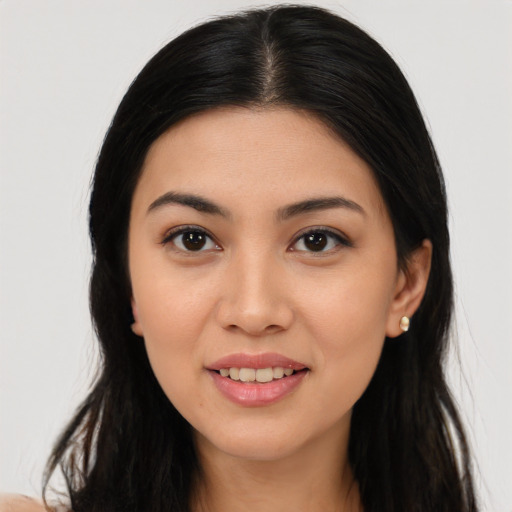 Joyful asian young-adult female with long  brown hair and brown eyes