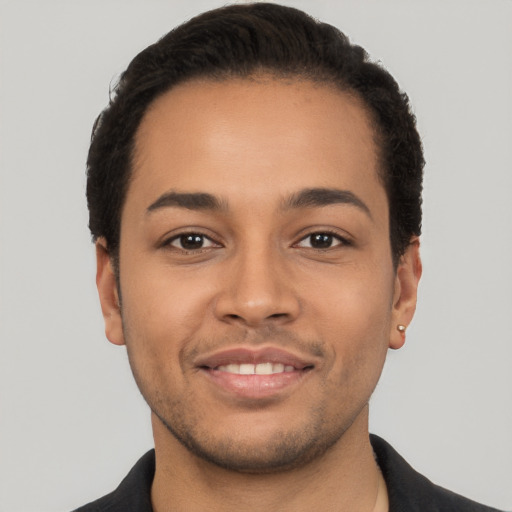 Joyful latino young-adult male with short  black hair and brown eyes