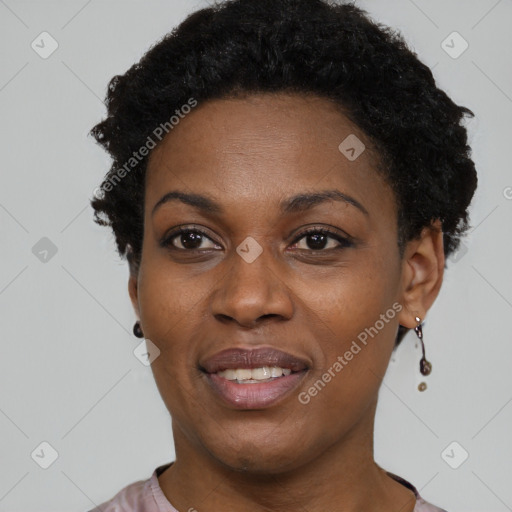 Joyful black young-adult female with short  black hair and brown eyes