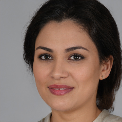 Joyful white young-adult female with medium  brown hair and brown eyes