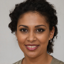 Joyful black young-adult female with medium  brown hair and brown eyes