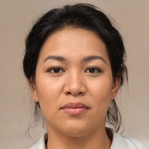 Joyful asian young-adult female with medium  brown hair and brown eyes
