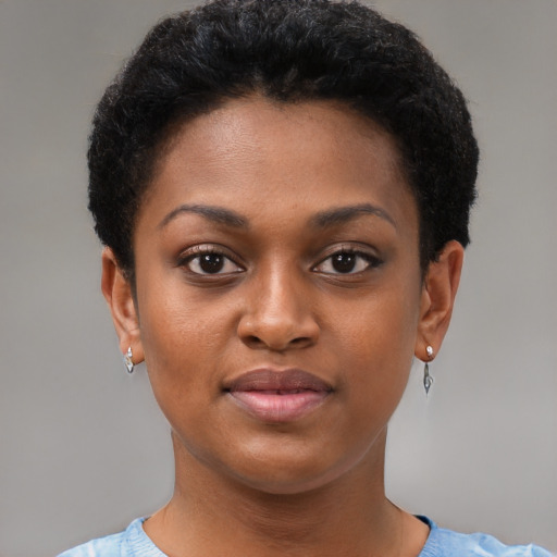 Joyful black young-adult female with short  black hair and brown eyes