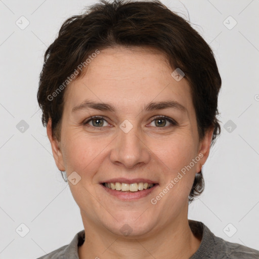 Joyful white adult female with short  brown hair and grey eyes