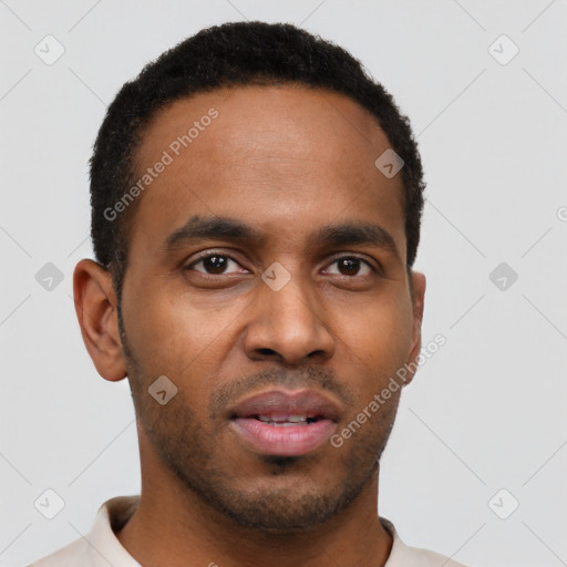 Joyful black young-adult male with short  brown hair and brown eyes