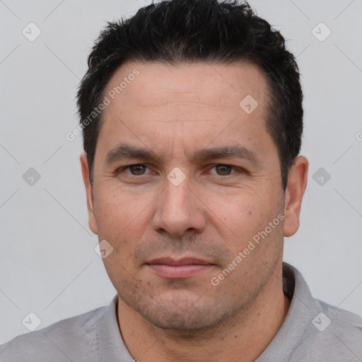 Joyful white adult male with short  black hair and brown eyes