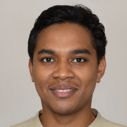 Joyful black young-adult male with short  black hair and brown eyes