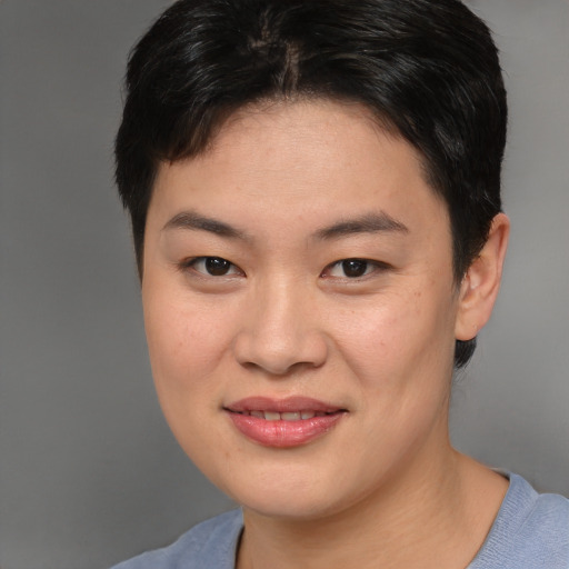 Joyful asian young-adult female with short  brown hair and brown eyes