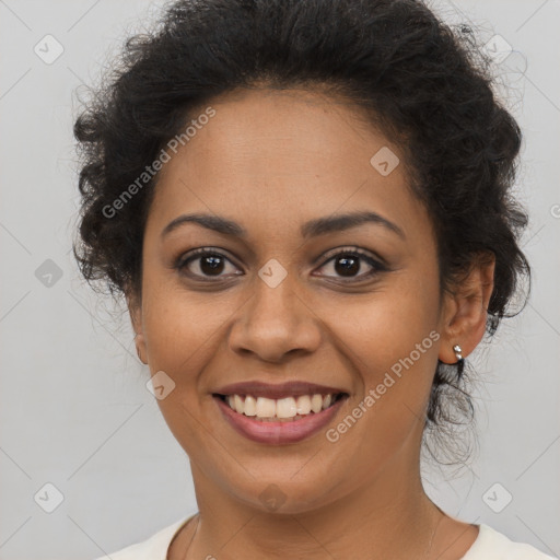 Joyful black young-adult female with long  brown hair and brown eyes