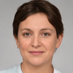 Joyful white adult female with short  brown hair and brown eyes