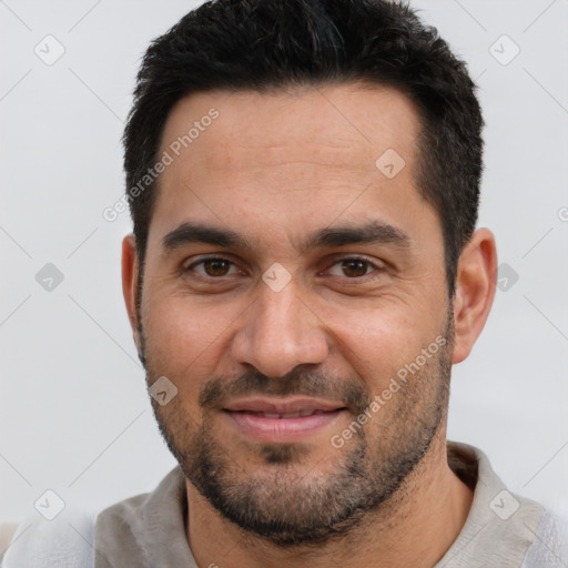 Joyful white young-adult male with short  black hair and brown eyes