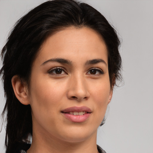 Joyful latino young-adult female with medium  brown hair and brown eyes