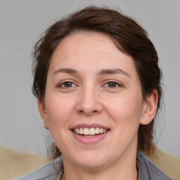 Joyful white adult female with medium  brown hair and brown eyes