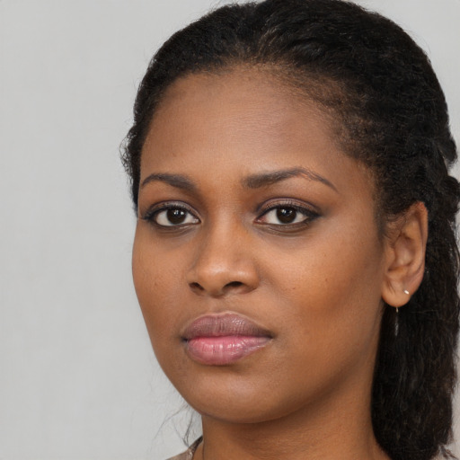 Neutral black young-adult female with long  brown hair and brown eyes