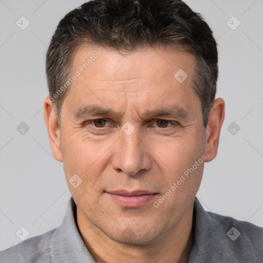 Joyful white adult male with short  brown hair and brown eyes