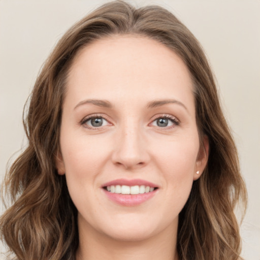 Joyful white young-adult female with long  brown hair and blue eyes