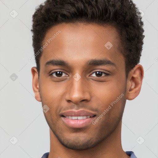 Joyful black young-adult male with short  brown hair and brown eyes