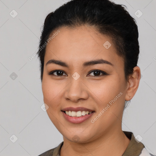 Joyful latino young-adult female with short  black hair and brown eyes