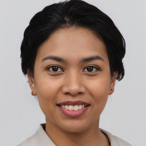 Joyful asian young-adult female with short  black hair and brown eyes