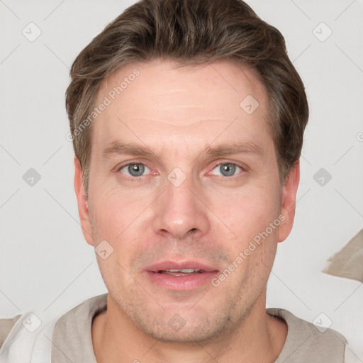 Joyful white adult male with short  brown hair and grey eyes