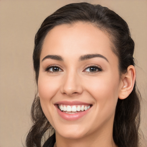 Joyful white young-adult female with long  brown hair and brown eyes