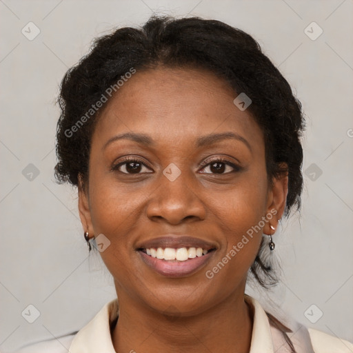 Joyful black adult female with medium  brown hair and brown eyes