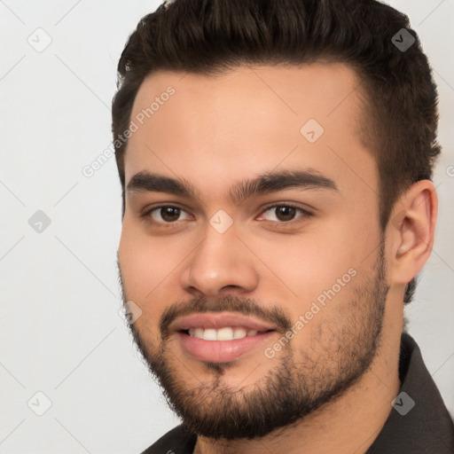 Joyful white young-adult male with short  black hair and brown eyes