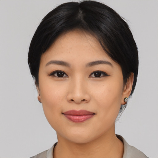 Joyful asian young-adult female with medium  black hair and brown eyes