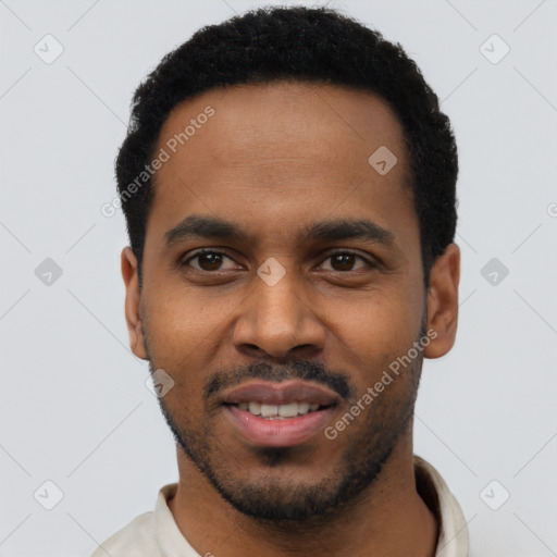 Joyful black young-adult male with short  black hair and brown eyes