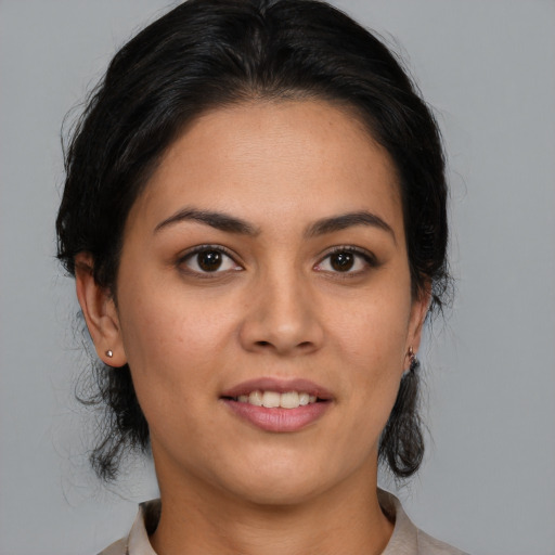 Joyful latino young-adult female with medium  brown hair and brown eyes