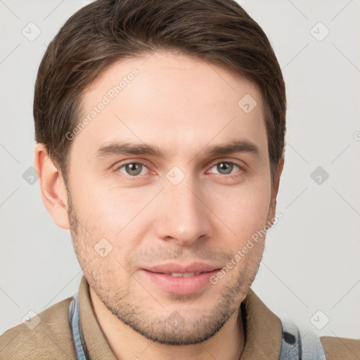 Joyful white young-adult male with short  brown hair and grey eyes