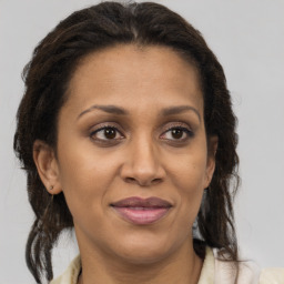 Joyful black adult female with medium  brown hair and brown eyes