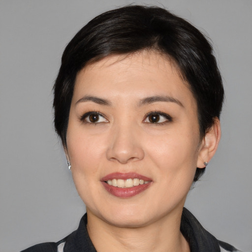 Joyful white young-adult female with medium  black hair and brown eyes