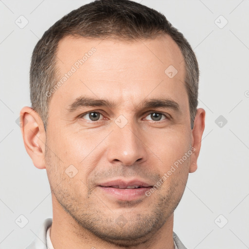 Joyful white adult male with short  brown hair and brown eyes