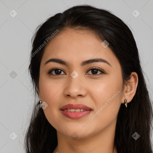 Joyful latino young-adult female with long  black hair and brown eyes