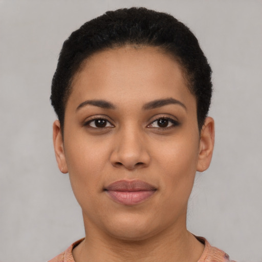 Joyful latino young-adult female with short  black hair and brown eyes