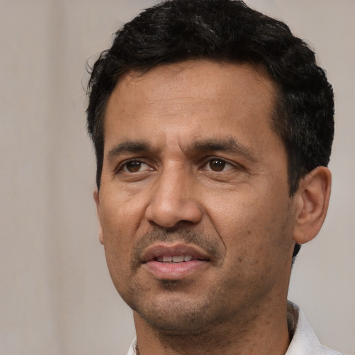 Joyful white adult male with short  black hair and brown eyes