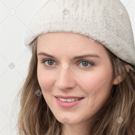 Joyful white young-adult female with long  brown hair and blue eyes