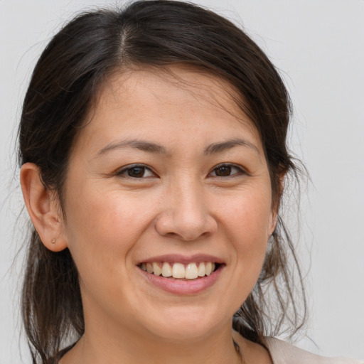 Joyful white young-adult female with medium  brown hair and brown eyes