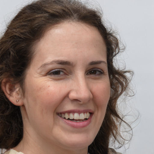 Joyful white adult female with medium  brown hair and grey eyes