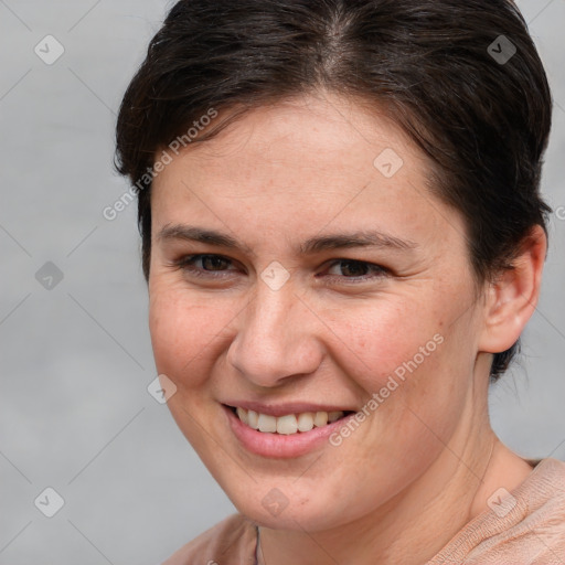 Joyful white young-adult female with medium  brown hair and grey eyes