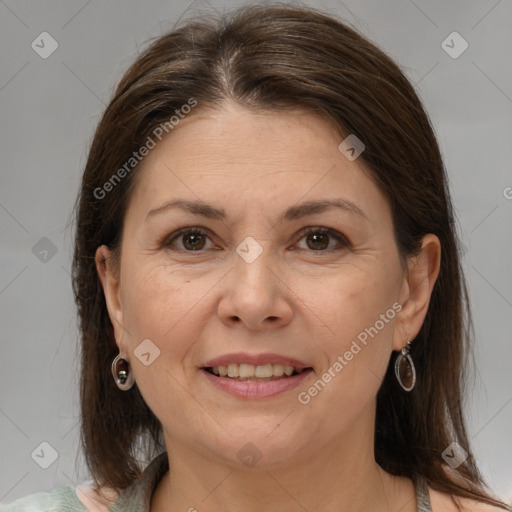 Joyful white adult female with medium  brown hair and brown eyes