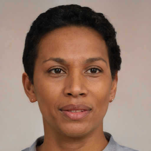 Joyful black adult female with short  black hair and brown eyes