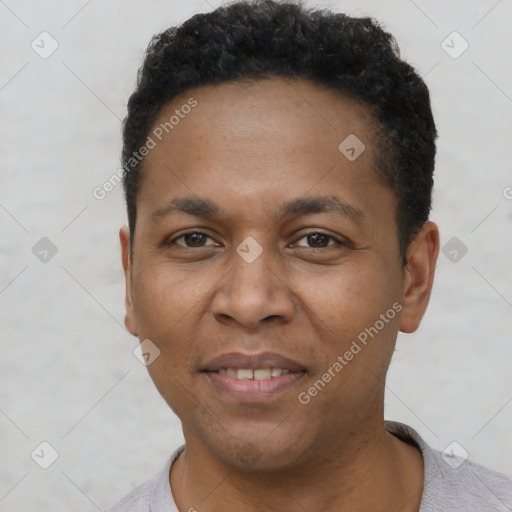 Joyful black young-adult male with short  black hair and brown eyes